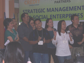 Manager-participants from Don Bosco Foundation for Sustainable Development, Upland Marketing Foundation Inc, Davao Provinces Rural Development Institute Inc and Oikocredit-Philippines present their social marketing workshop output in a song.