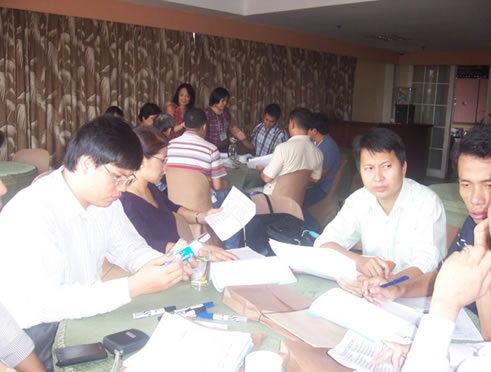 Cambodian participants define changes in structures, systems and staffing resulting from a shift in social enterprise strategy during a workshop on organizational architecture.